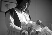 Grey Nun and baby. Fort Smith, NWT, 1949. (N-2001-002-0183)  