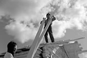 Frank and Mary Codzi building a cabin. Colville Lake, NWT, 1968. 