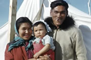 Tommy Thrasher and family outside their tent. East-3 (Inuvik), NWT, 1956.