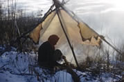 A woman smoking a hide. Nahanni Butte, NWT, 1961.  