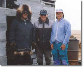 Inuvialuit Elders Edgar Kotokak (left) and Emmanuel Felix (centre) along with one of Nuligak's grandsons, Angus Cockney (right), at Avvaq in 1995