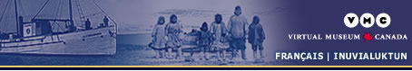 Inuvialuit family in front of a dog sled
